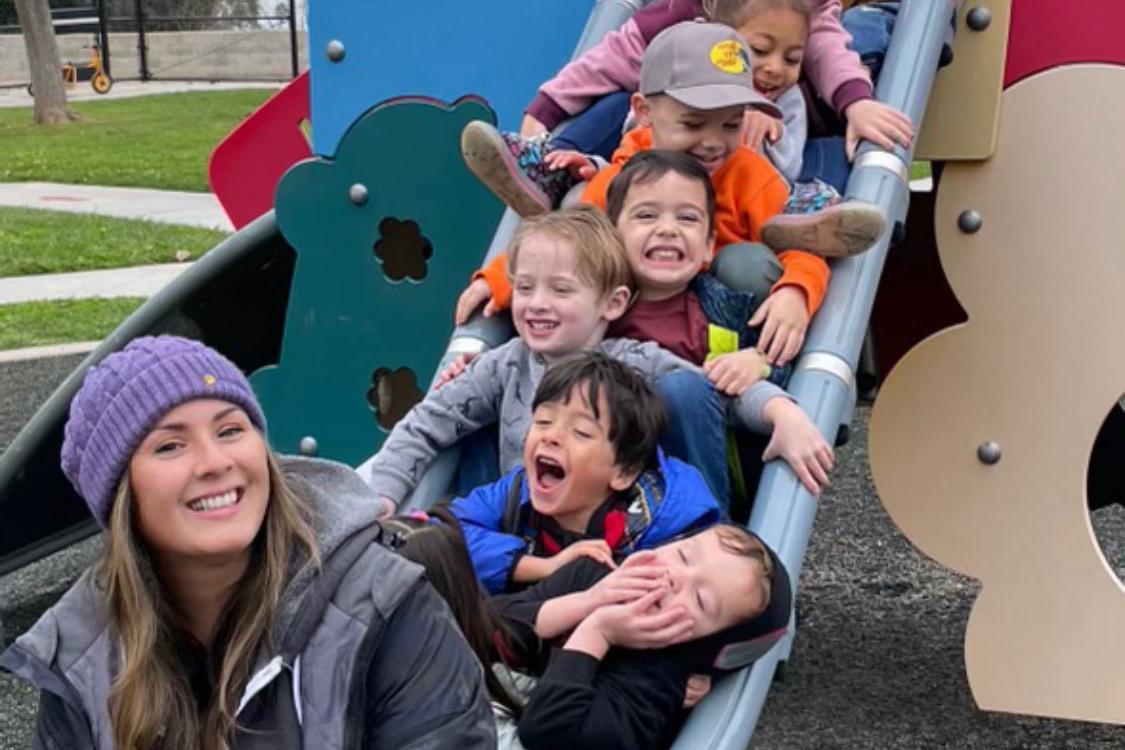 Children and teacher on slide